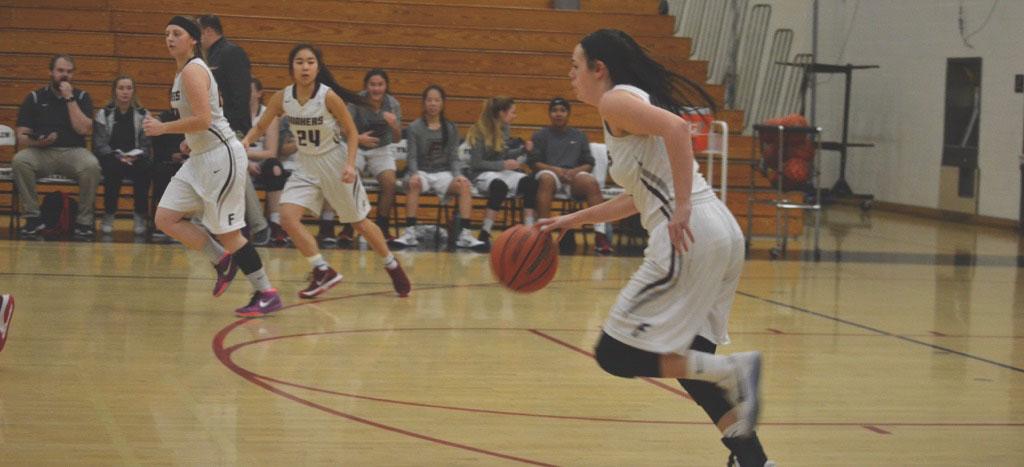 Bria Dixson (10) swiftly dribbles the ball down the court with teammates by her side. The varsity girls basketball team was ranked 34th in the state last season and hopes to move up in the rankings this coming season. Photo by Jamarius Jenkins