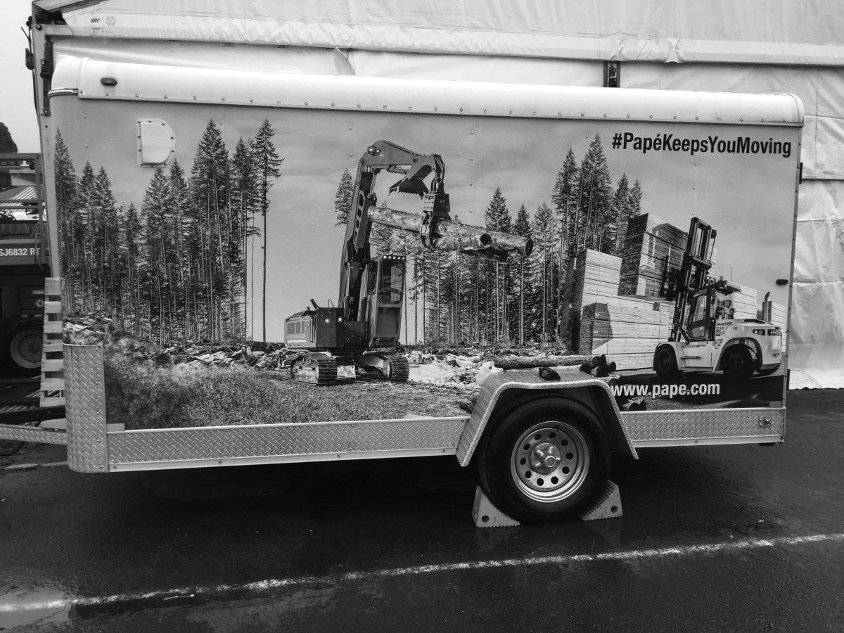 An advertisement for the Oregon Logging Conference’s outdoor display. Papé is a company that employs Oregon loggers. Photo by Griffin Schumock.