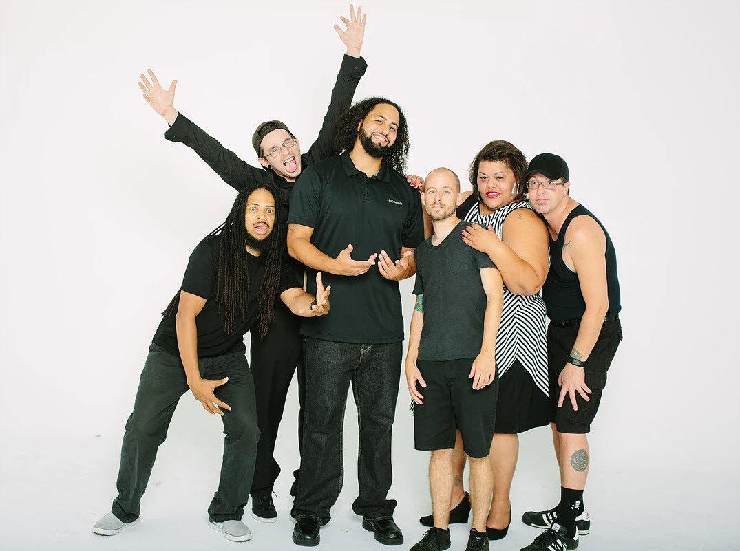 Jamieson (third from right) poses with his band, Speaker Minds. Jamieson plays drums, and is involved in music as well as teaching. Photo by Martin Van Londen.