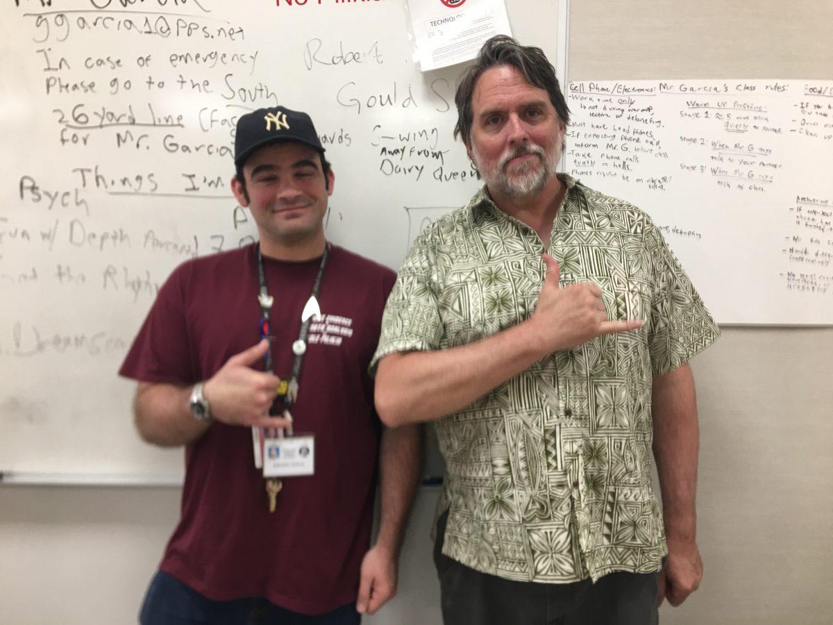 Hawaiian Club’s two advisors Greg Garcia and David Stroup doing the shaka sign, which is usually translated from Hawaiian to mean ‘hang loose.’ Photo by Abby Chapman