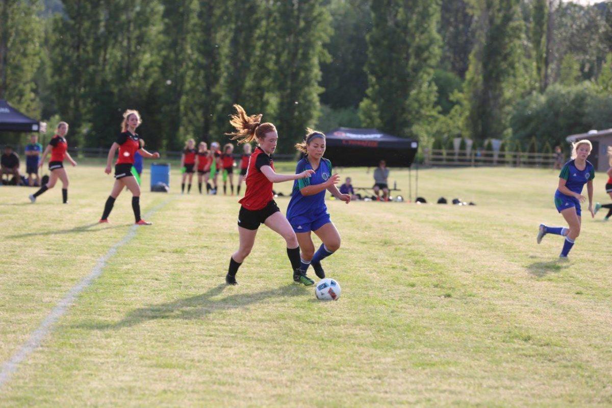 Athlete Delaney Griffin (11) fights for the ball in a game of soccer. The grit and determination of female athletes are frequently erased by media. Photo by Heather Seals.