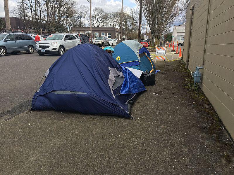 Photo credit to Wikimedia Commons. A small homeless camp in the Buckman neighborhood of Northeast Portland. Tents such as these do very little to provide shelter throughout the year, but even less so in the harsh winter months.
