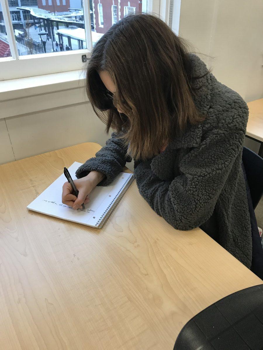 Zola Thomas (10) writes a poem for the FHS creative magazine. The publication welcomes submissions from all Franklin Students.
Photo Credit: Sadie Tresnit
