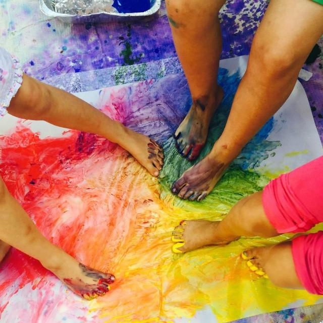 Children painting with their feet.  At CHAP one of the most common art projects is finger painting and being able to work with paint.  Photo from the CHAP website.