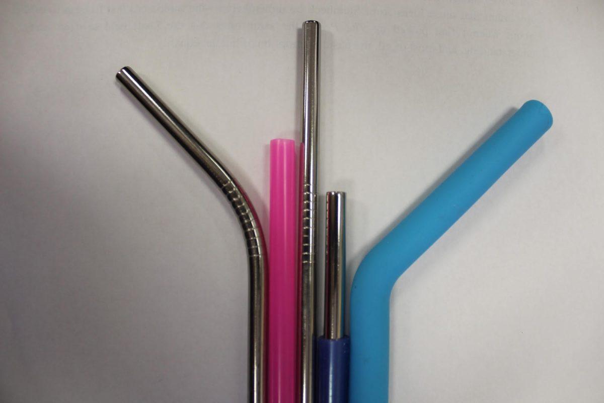 Photo Credit: Abby Chapman. From left to right: a bent metal straw, a plastic one-use straw, a long metal straw, a short metal straw with a plastic grip, a bendy reusable straw made of plastic. Portland’s one-use utensil law will take place within the year, limiting the amount of plastic straw consumers will use.