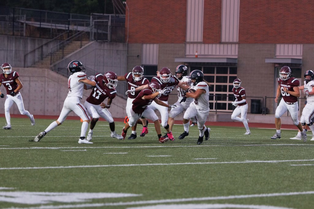 Franklin football players attempting to tackle Sandy High School running back, Mataio Olomua. Name, Image, and Likeness (NIL) has and will continue to impact high school student-athletes for years to come. Photo by Ailinh Van.