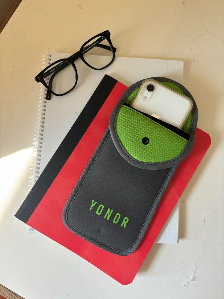 A Cleveland student’s Yondr pouch, surrounded by other school supplies. Beginning this year, some PPS schools began  requiring students to show their pouches upon entering school in the morning.  Photo by 