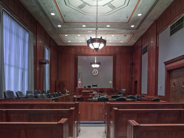 A jury box in a small courtroom. Whether in the courts of law, or the court of public opinion, are we as a society holding male public figures accountable? Photo from Canva.