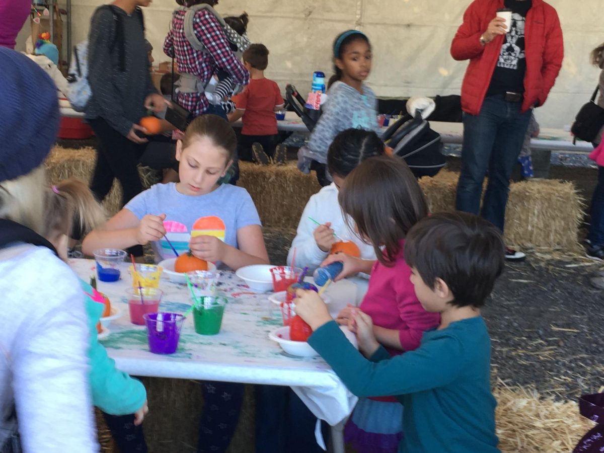 Children and families painting tiny pumpkins on hay bales at the Portland Nursery Apple Festival in the fall of 2018. This was one of many engaging community events we lost due to the COVID-19 pandemic, which are incredibly important for connection, growth, and well-being within a community. Photo by Kari Atlansky.
