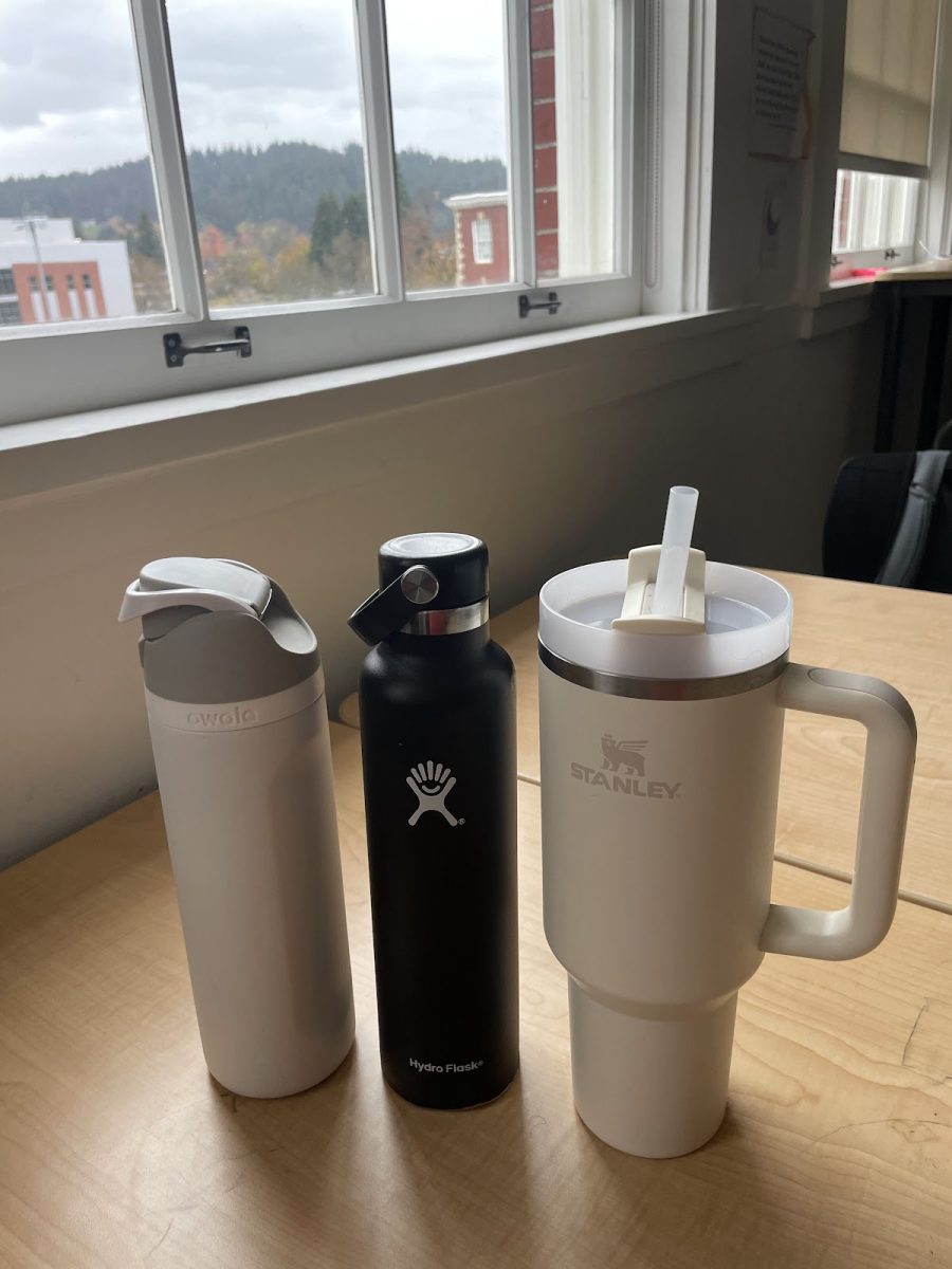 Owala, Hydro Flask, and Stanley water bottles on a Franklin student's desk. The controversy of which of these three popular cups is best has been spreading based on personal preferences. Photo by Sofie Salewsky.
