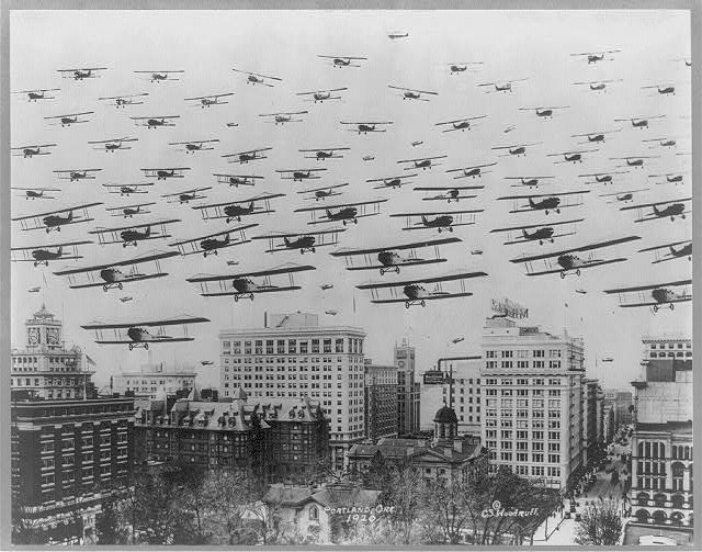 Photo Caption: Biplanes flying over downtown Portland in 1920. The most popular plane of World War I, biplanes were used throughout the First World War and into the 1930s. Photo by C.S. Woodruff, accessed through the Library of Congress Prints and Photographs Division.
