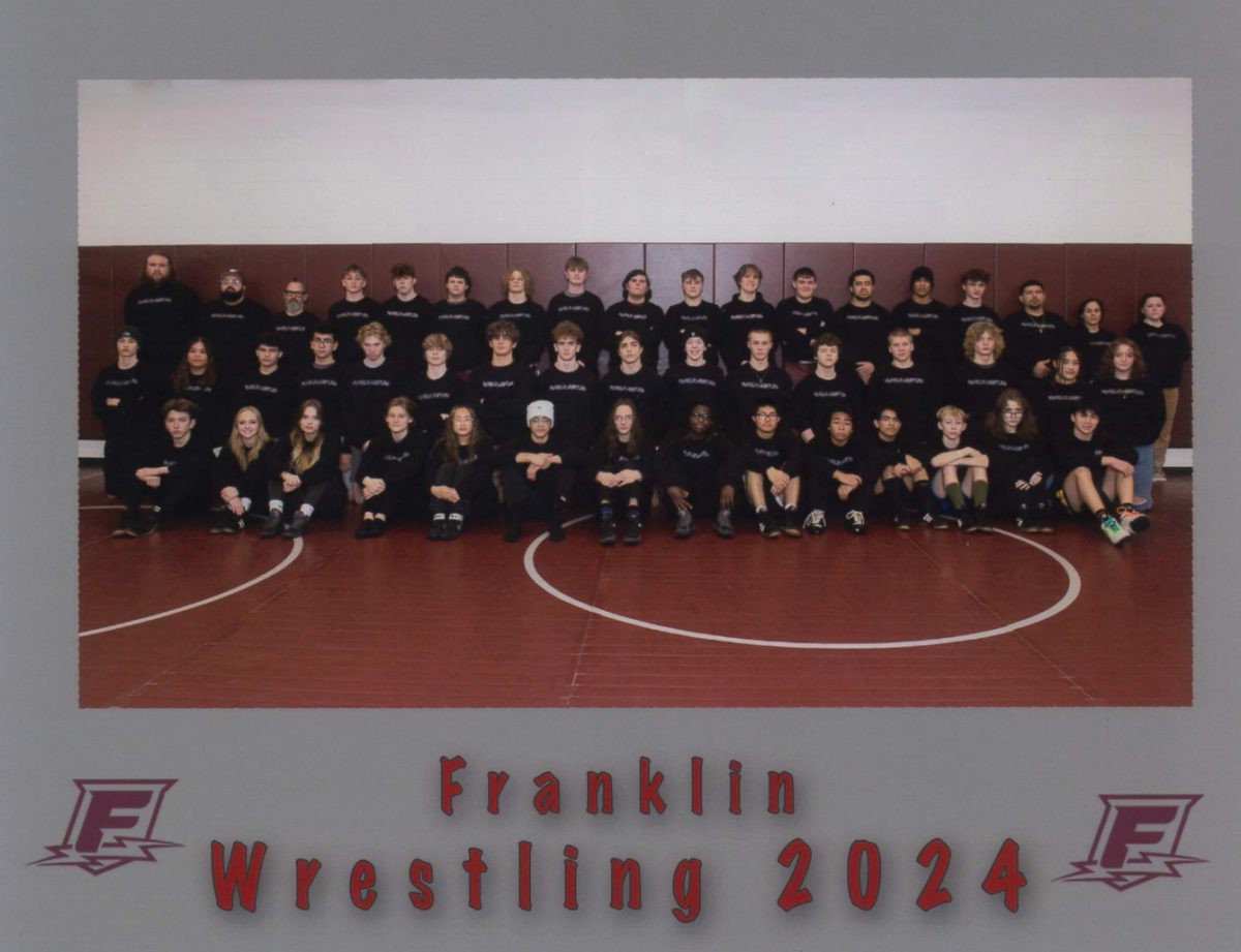 The 2024 Franklin Wrestling team on their media day. This group is defined by their passion for their sport and the incredible coaches who support their growth. Photo via Lozen Warner.