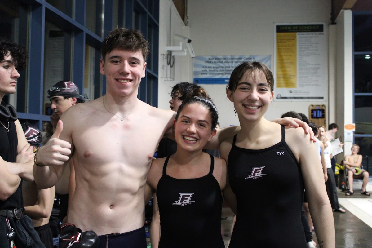 Swim captains Guthrie Castile, Annalise Shorb, and Ruby Rippetoe-Crawford during a Portland Interscholastic League (PIL) swim meet. Franklin’s swim team practices at the East Portland Community Center, but holds swim meets at Matt Dishman Community Center’s indoor pool. Photo by Ailinh Van.