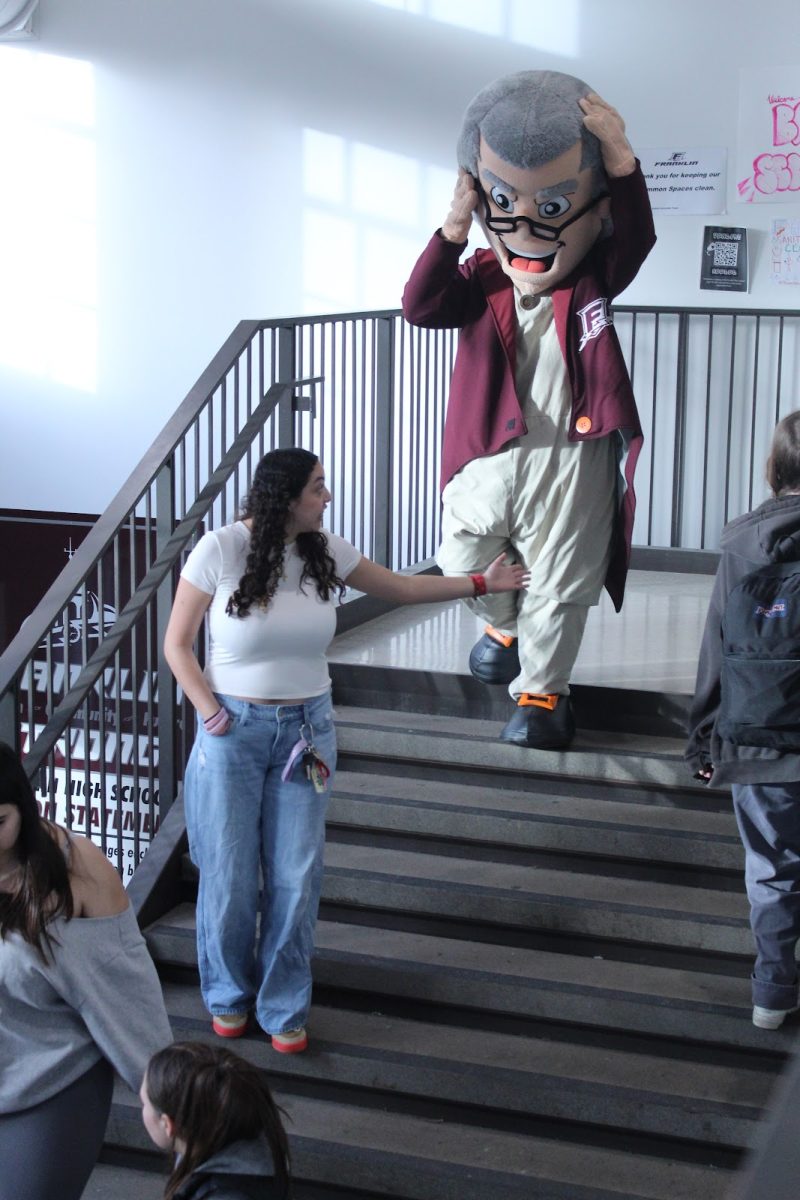 A member of ASB helps guide Benji, the Franklin mascot, down a flight of stairs. ASB is one of the many forms of student leadership at Franklin. Photo by Ailinh Van.