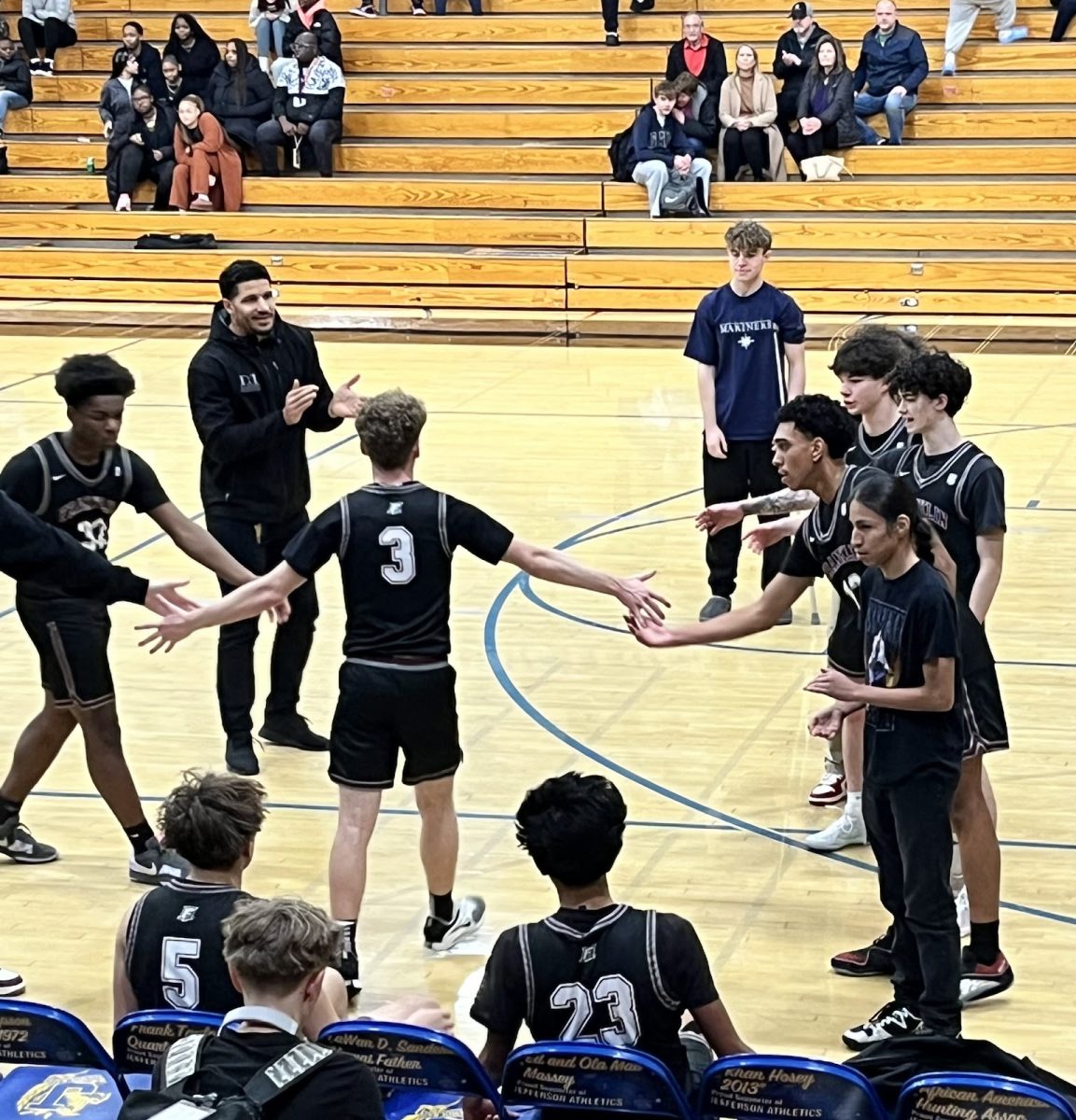 Trey Owens runs through a high-five line of his teammates at the beginning of Franklin's 64-65 loss at Jefferson High School on Jan. 7. Owens is one of the familiar faces from last year’s  Franklin’s men’s varsity basketball team. Photo by 