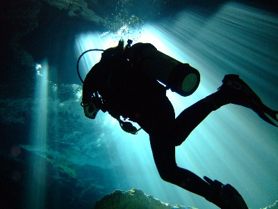 A diver, beneath the surface of the water. Scuba diving is one of a growing list of extreme sports, which are characterized by adrenaline-inducing properties and changing environments. Photo via Karl Anderson.