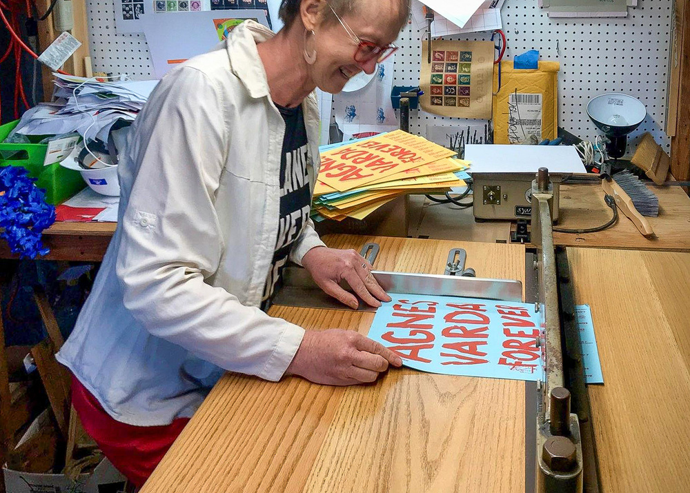 Jennifer “JJ” Jones works on one of the posters for the Agnès Varda Forever project. The brain-child of local artists, this project aims to educate people about French filmmaker Agnès Varda. Photo by Niko Courtelis. 