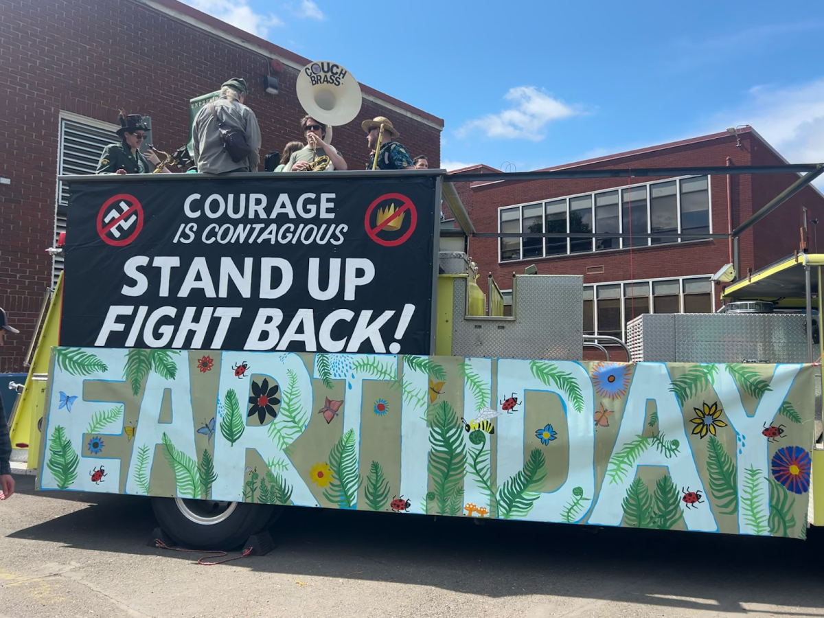 A themed float, decorated with the words “Earth Day” and the slogan “Courage is contagious, stand up and fight back!” On April 26, an Earth Day parade and gathering at Sunnyside Environmental School aimed to bring awareness to the rising fight for climate justice. Photo by 