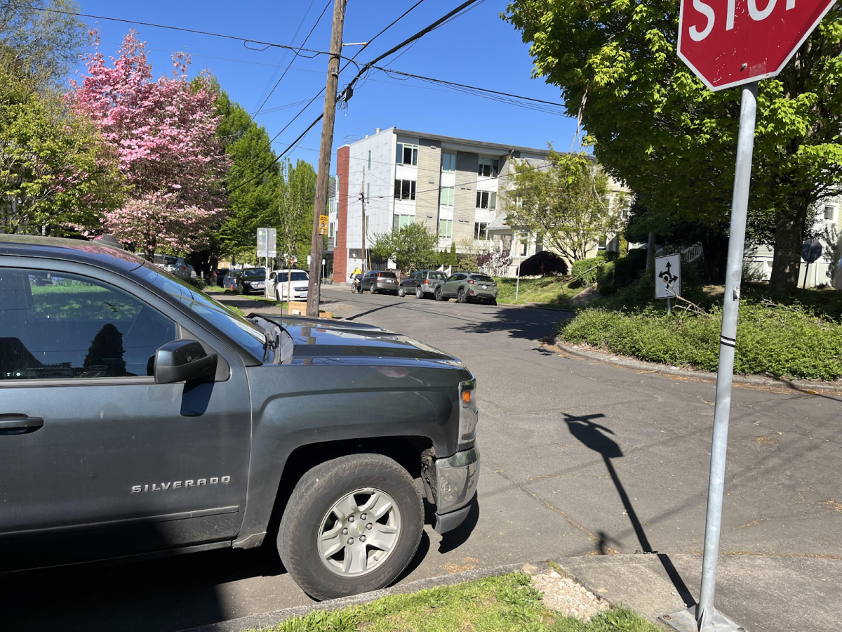 A large vehicle parked up to the curb. Cars parked close to an intersection can restrict other drivers' views, making an intersection more prone to accidents. Photo by 