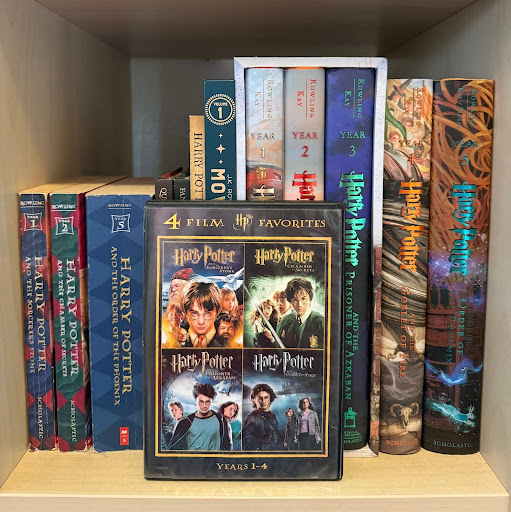 A “Harry Potter” DVD on a bookshelf in front of various “Harry Potter” books. “Harry Potter” is just one franchise of many that has produced successful movies based off of the books. Photo by Ella Grimes.