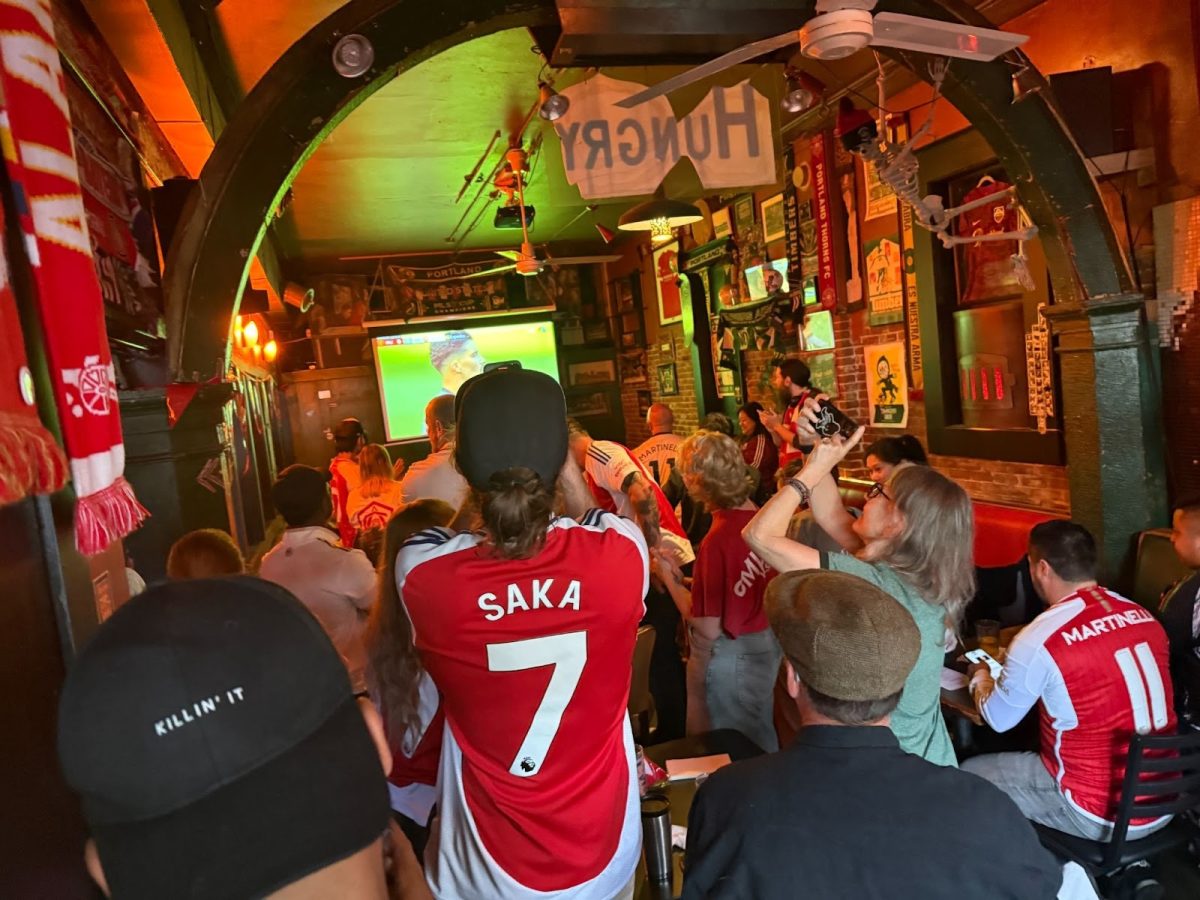 The view of an Arsenal game inside Beulahland, a popular sports bar in Portland. Beulahland shows every Arsenal game of the season, attracting staggering crowds each time. Photo by Evie Bell.