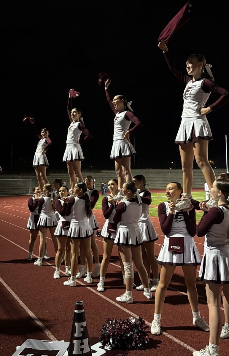 The Franklin cheer team pictured during the 2025 homecoming football game. The cheer team shows up every Friday night during the fall to engage the crowd of students and families and cheer on the football team. Photo via Savannah Williams.