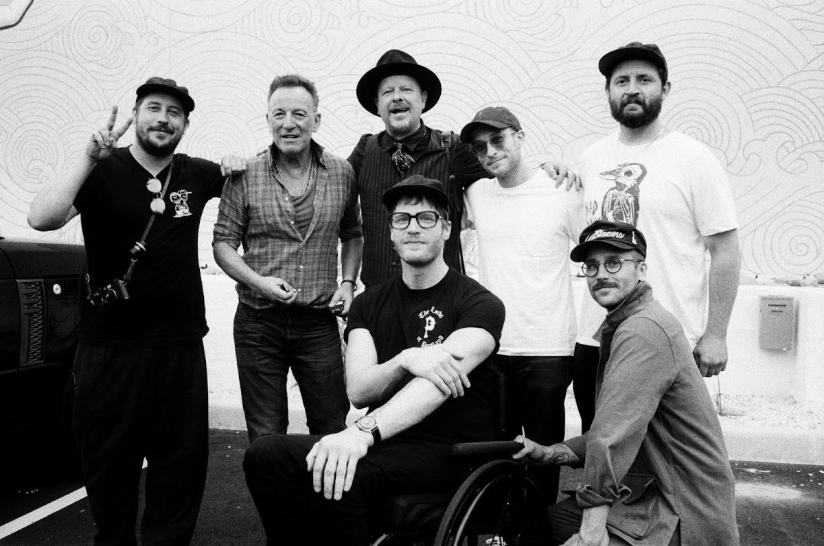 Bruce Springsteen poses backstage with the band Portugal. The Man. The recent film “Springsteen: Deliver Me from Nowhere” tells the personal story of the creative process behind Springsteen’s 1982 album “Nebraska.” Photo via Zach Carothers.