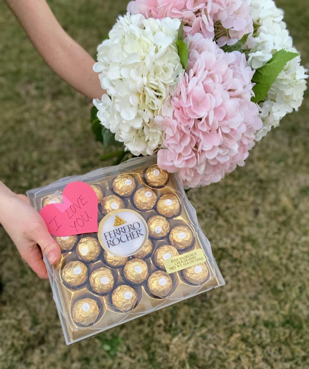Two outstretched hands offer a box of chocolates and a flower bouquet to someone unseen. Dating can be a difficult and confusing process — especially for teens.