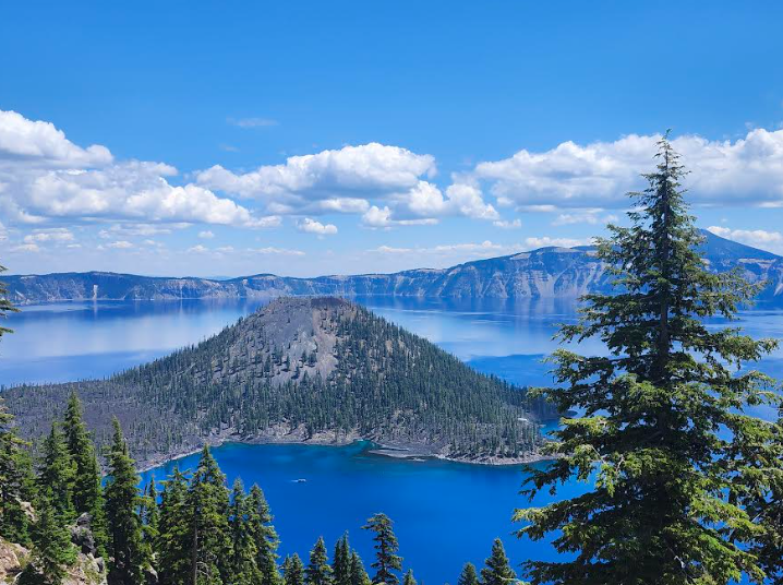 Southern Oregon’s Crater Lake reflects the beautiful blue sky on a sunny summer day. Crater Lake is one of many destinations hikers can experience along the Pacific Crest Trail (PCT). Photo by 
