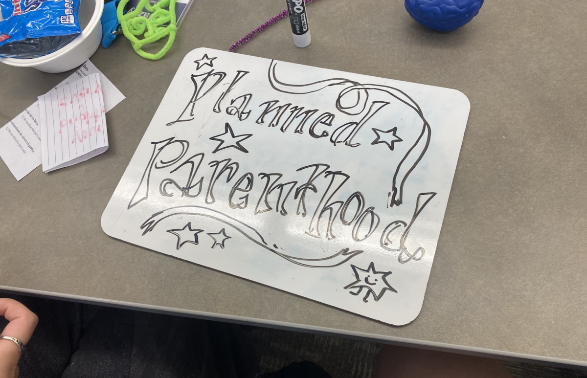 A whiteboard with “Planned Parenthood” written in erasable marker calligraphy. Planned Parenthood Columbia Willamette is the Planned Parenthood affiliate in the Portland area. Photo by Easton Atlansky. 